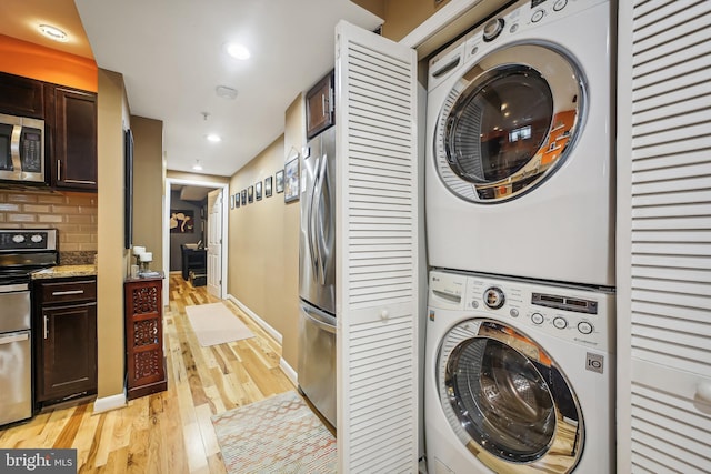 washroom featuring light wood-type flooring and stacked washer and dryer