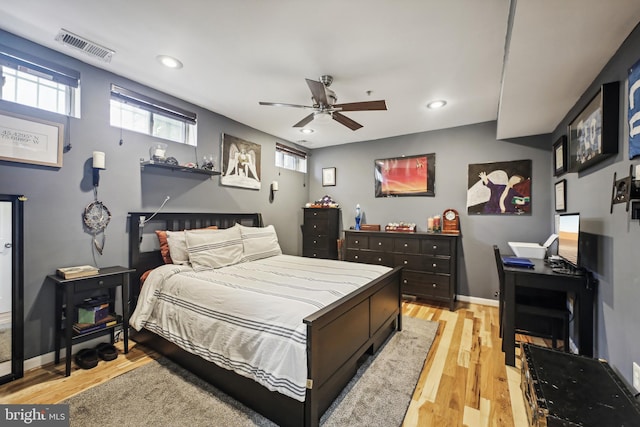 bedroom with light hardwood / wood-style flooring and ceiling fan