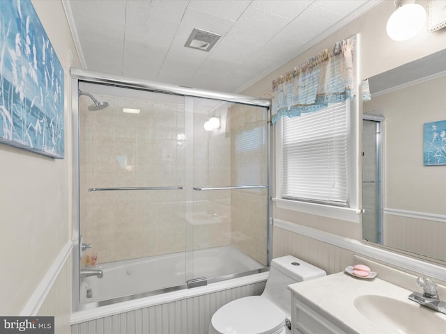 full bathroom with crown molding, combined bath / shower with glass door, toilet, and vanity