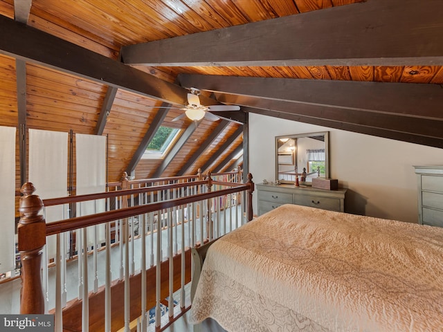 bedroom with ceiling fan, vaulted ceiling with skylight, multiple windows, and wooden ceiling