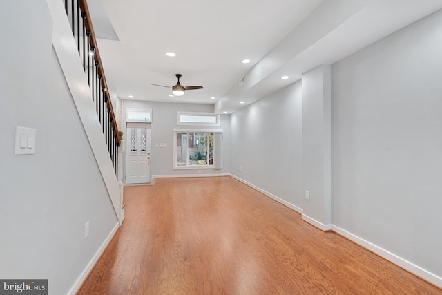 unfurnished living room with light hardwood / wood-style flooring and ceiling fan