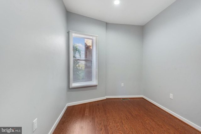 empty room with hardwood / wood-style floors