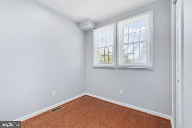 spare room featuring wood-type flooring