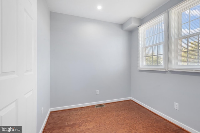 unfurnished room with hardwood / wood-style flooring