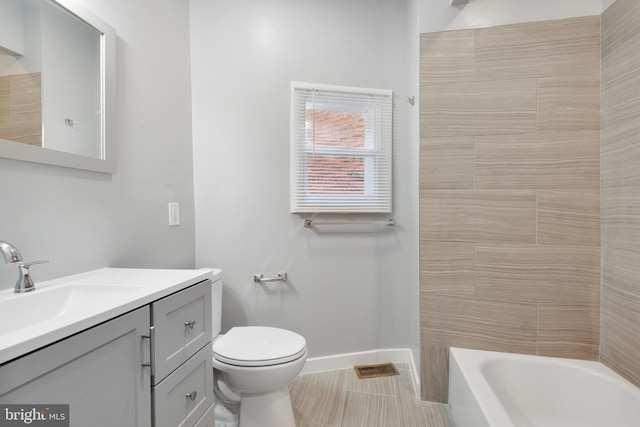 full bathroom featuring vanity, bathing tub / shower combination, toilet, and tile patterned floors