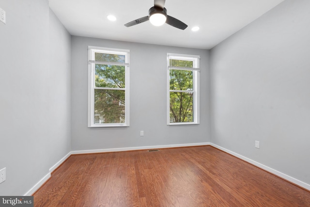 empty room with ceiling fan and wood-type flooring