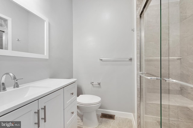 bathroom with vanity, toilet, and an enclosed shower