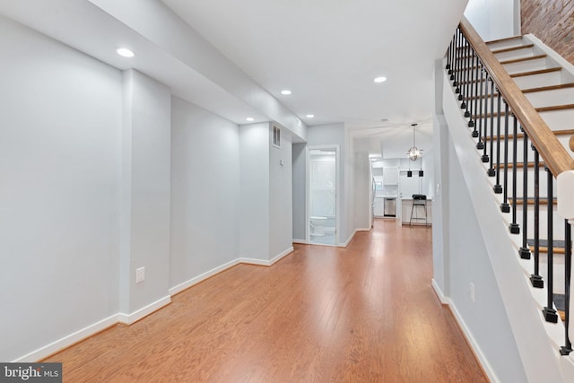 interior space featuring light hardwood / wood-style flooring and an inviting chandelier