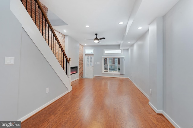 unfurnished living room featuring hardwood / wood-style floors and ceiling fan