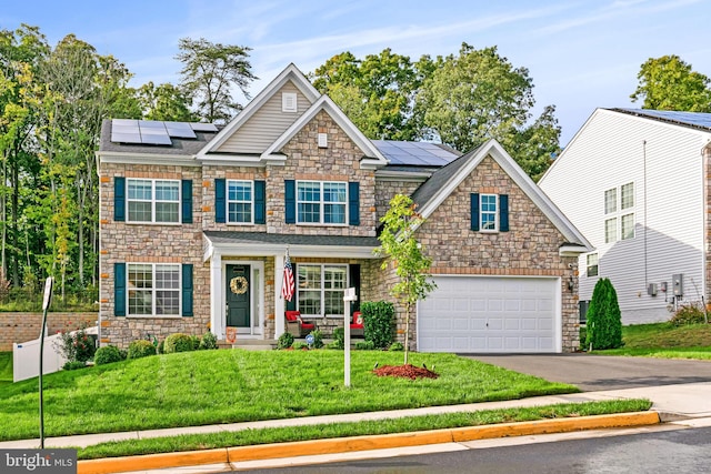 craftsman house with solar panels, a garage, and a front lawn