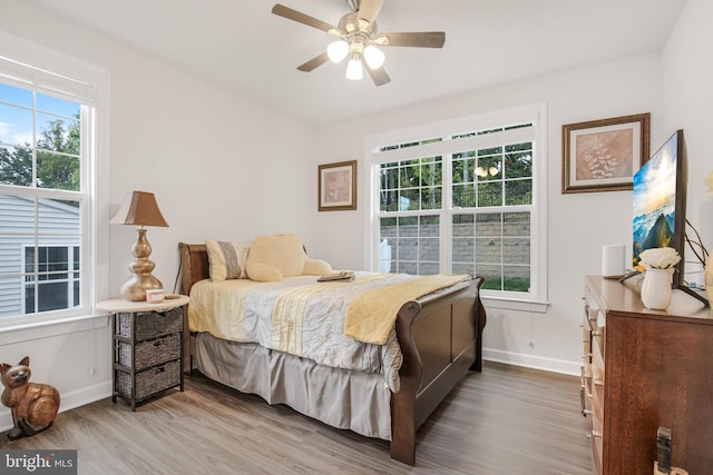 bedroom with hardwood / wood-style floors and ceiling fan