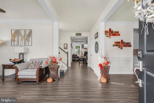 foyer featuring ornamental molding and dark wood-type flooring