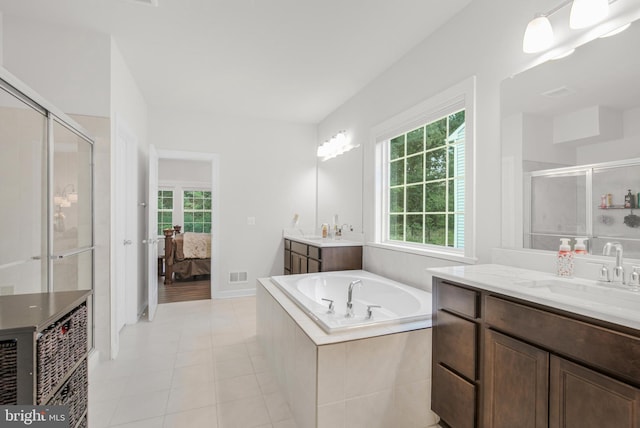 bathroom with vanity, a wealth of natural light, shower with separate bathtub, and tile patterned flooring