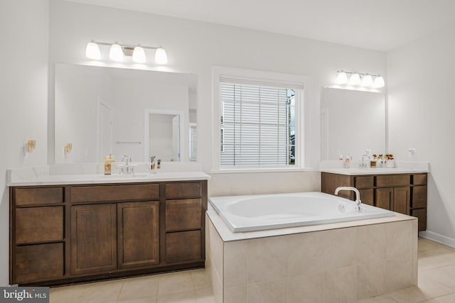 bathroom featuring vanity, tiled bath, and tile patterned flooring