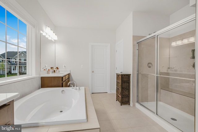 bathroom featuring vanity, tile patterned flooring, and plus walk in shower