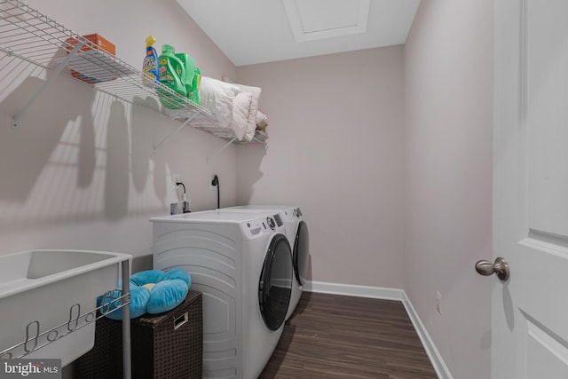 laundry area featuring dark wood-type flooring and washing machine and clothes dryer