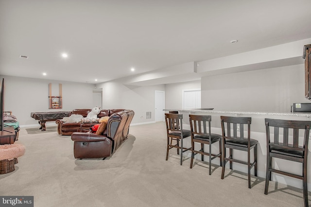 carpeted living room featuring bar and billiards