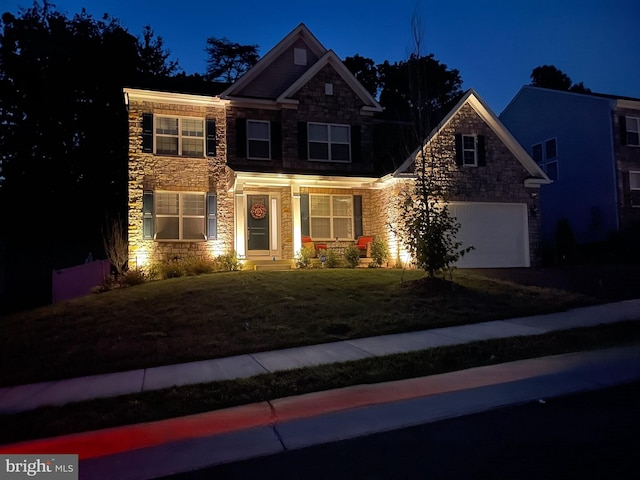 craftsman-style home with a lawn and a garage