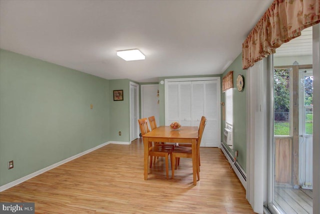 dining room featuring light hardwood / wood-style flooring and a baseboard heating unit