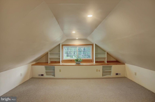 bonus room featuring lofted ceiling and carpet