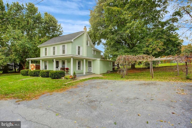 view of front of property with a front lawn and a porch