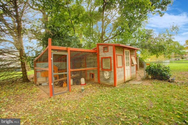 view of outbuilding featuring a yard