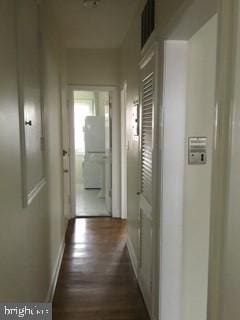 hallway with dark wood-type flooring