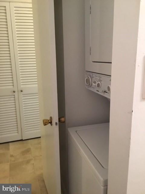 651 Constitution Ave NE, Washington, DC 20002 - clothes washing area with stacked washing maching and dryer and laundry area