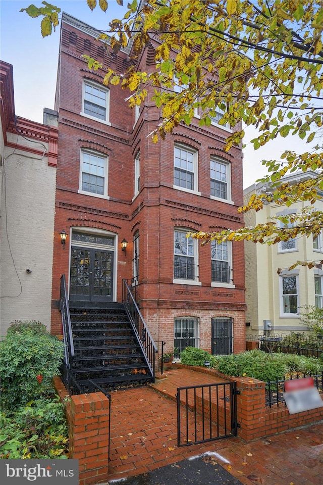 651 Constitution Ave NE, Washington, DC 20002 - townhome / multi-family property featuring brick siding, a fenced front yard, and a gate