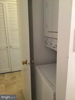 laundry room featuring stacked washer and clothes dryer