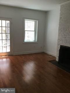 unfurnished living room featuring a fireplace and hardwood / wood-style floors