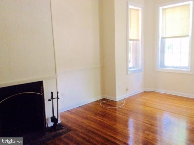 unfurnished living room featuring hardwood / wood-style floors