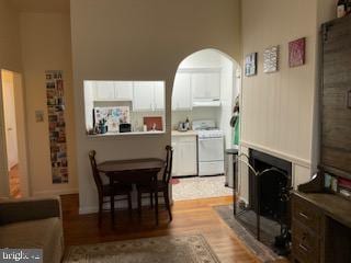 651 Constitution Ave NE, Washington, DC 20002 - dining area with arched walkways, a towering ceiling, and light wood-style floors