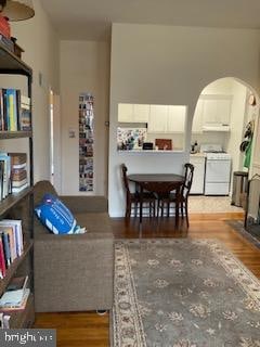 living room featuring hardwood / wood-style flooring and independent washer and dryer