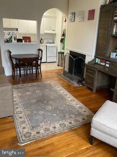 living room with hardwood / wood-style flooring and washer and dryer