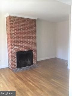 unfurnished living room featuring a fireplace and hardwood / wood-style floors