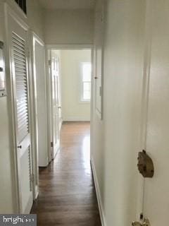 hallway with dark hardwood / wood-style flooring