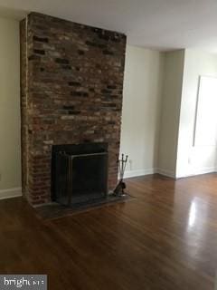 unfurnished living room featuring a fireplace and dark hardwood / wood-style flooring