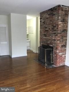 unfurnished living room featuring dark hardwood / wood-style floors