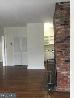 unfurnished living room with dark hardwood / wood-style floors