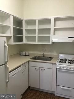 kitchen featuring white appliances, white cabinetry, and sink