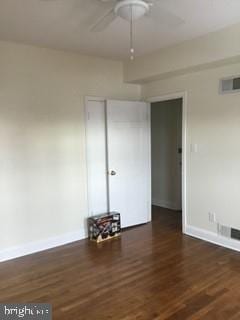 empty room featuring ceiling fan and dark hardwood / wood-style floors