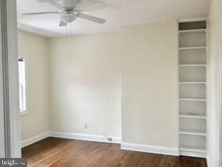 empty room featuring dark hardwood / wood-style floors and ceiling fan