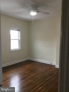 empty room with ceiling fan and dark hardwood / wood-style floors