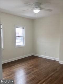 empty room featuring ceiling fan and dark hardwood / wood-style flooring