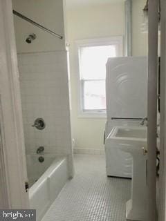 bathroom with tiled shower / bath combo, tile patterned flooring, and vanity