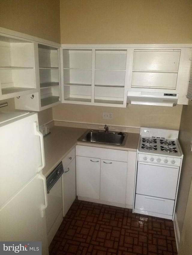 kitchen featuring sink, extractor fan, white appliances, and white cabinetry