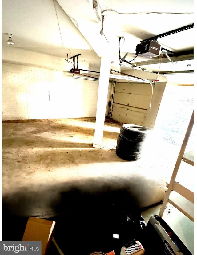 interior space featuring a garage door opener and concrete floors