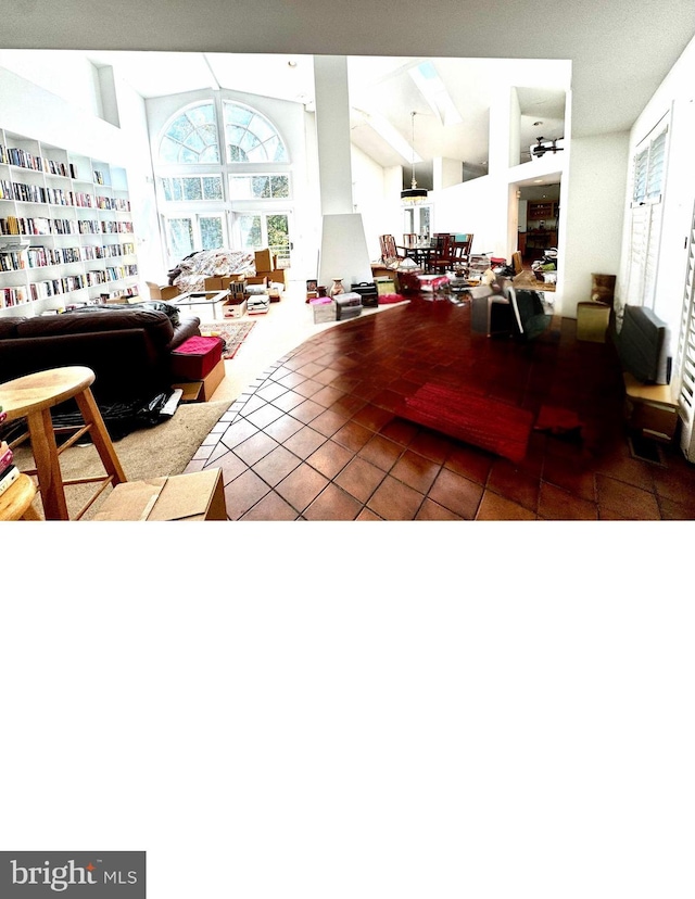 tiled living room with beam ceiling, high vaulted ceiling, and ceiling fan