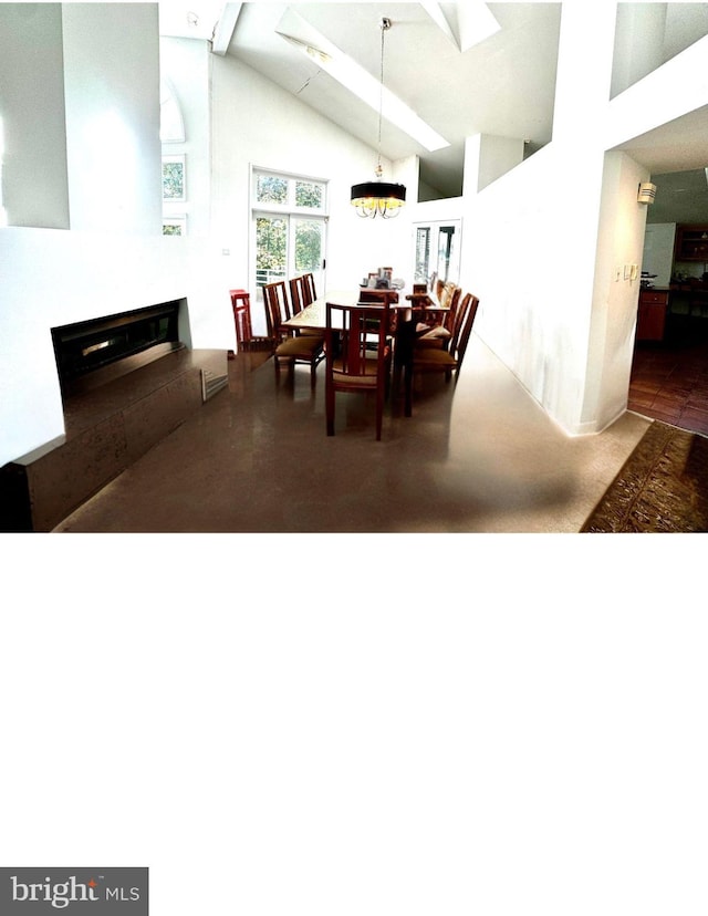 dining space featuring beam ceiling, a chandelier, and high vaulted ceiling